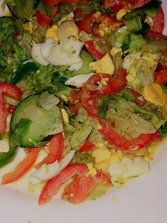 A picture of Vegetable salad served with boiled eggs.