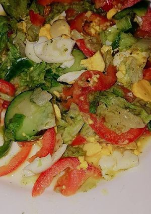 A picture of Vegetable salad served with boiled eggs.