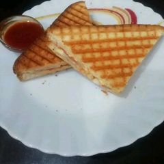 A picture of Vegetables Grilled Sandwich with Cheese Spread.