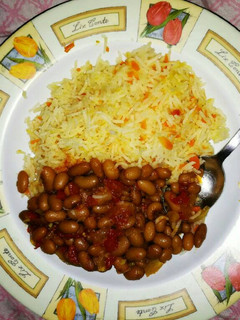 A picture of Carrot Rice and yellow beans.
