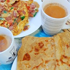 Veggies loaded omlette with parathay A picture of Veggies loaded omlette with parathay.