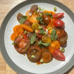 A picture of Heritage/heirloom tomatoes summer salad with olive oil and pomegranate molasses #CookTheSeason.