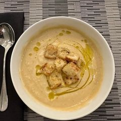 A picture of Creamy Cauliflower Soup with Rosemary Olive Oil.