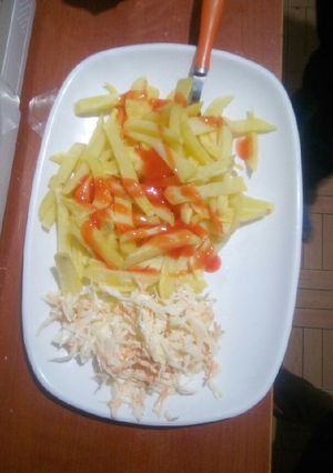 A picture of Homemade chips and coleslaw salad.