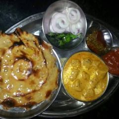 A picture of Khooba roti, gatte ki sabji, lahsun chutney mirch achar, salad.