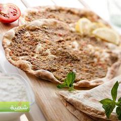 A picture of Open-faced meat pies - lahem bi ajeen.