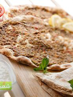 A picture of Open-faced meat pies - lahem bi ajeen.