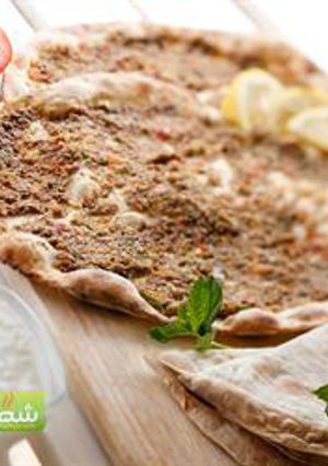 A picture of Open-faced meat pies - lahem bi ajeen.