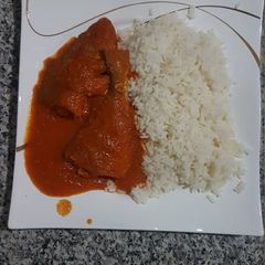 A picture of Croaker fish stew and rice.