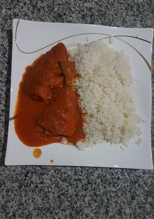 A picture of Croaker fish stew and rice.