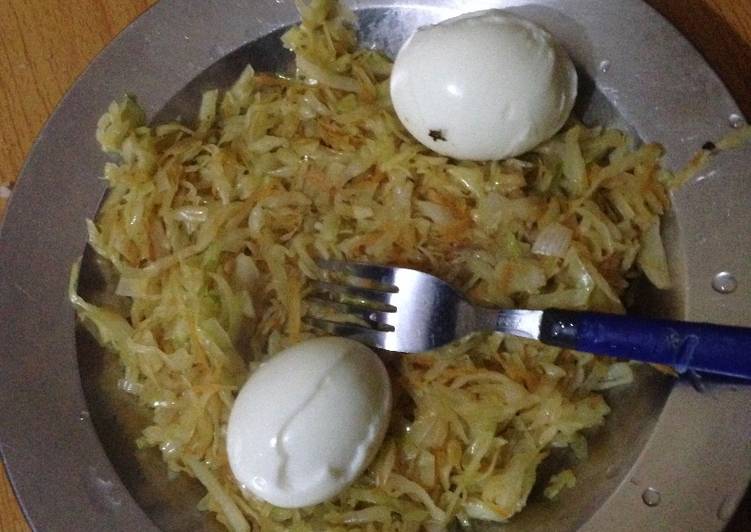 Steamed cabbage and carrots served with hard boiled eggs