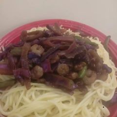 A picture of Stir fry prawns with spaghetti.