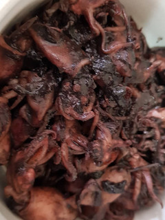 A picture of Squid cooked with ink and tamarind.