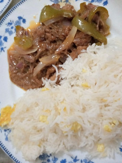 A picture of Beef dry chilli with egg fried rice.