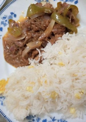 A picture of Beef dry chilli with egg fried rice.