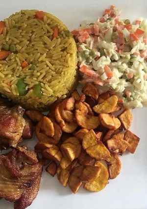 A picture of Fried rice with chicken and plantain.