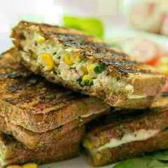 A picture of Grilled cheese and corn sandwich.