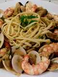 Linguines de limón salteados con frutos secos y marisco al ajillo con alcachofas