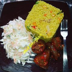 A picture of Fried rice with coleslaw and pomo.