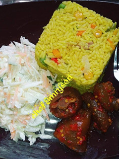 A picture of Fried rice with coleslaw and pomo.