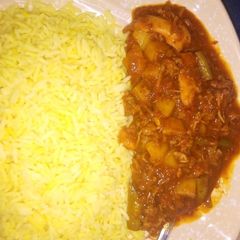 A picture of Curry rice with potatoe soup.