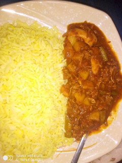 A picture of Curry rice with potatoe soup.