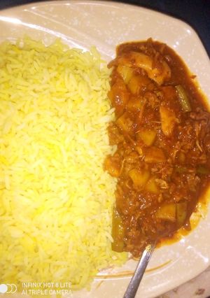 A picture of Curry rice with potatoe soup.