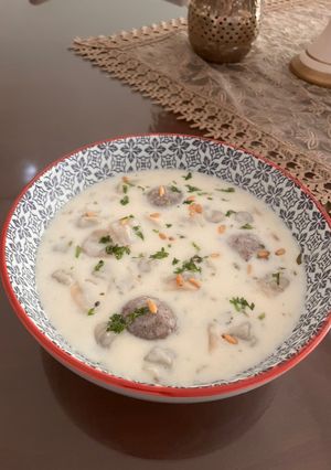 A picture of Shish Barak - Lebanese meat dumplings in cooked yogurt.