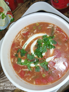 A picture of Tomato soup with veggies.