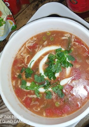 A picture of Tomato soup with veggies.