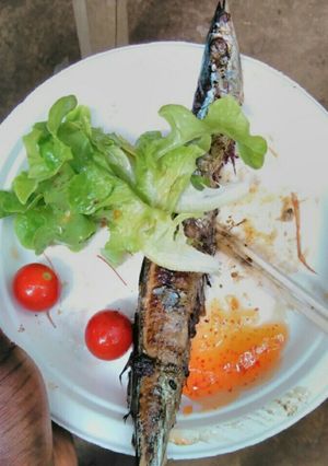A picture of Barbecue styled fish with vegetable.