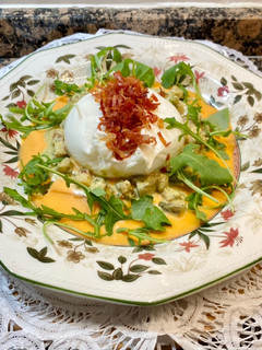 Una foto de Ensalada de burrata y rúcula, tartar de tomate y crujiente de jamón