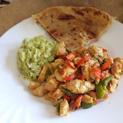 A picture of Stir fried chicken breast with guacamole.