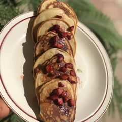 A picture of Pancakes with strawberry drizzle.