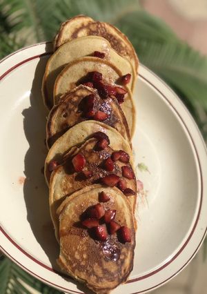 A picture of Pancakes with strawberry drizzle.