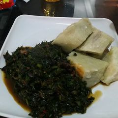 A picture of Yam with ugu sauce.
