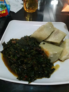 A picture of Yam with ugu sauce.
