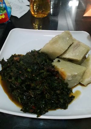 A picture of Yam with ugu sauce.