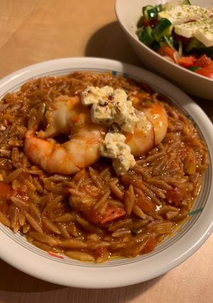 A picture of Orzo with prawn, tomato and feta cheese.