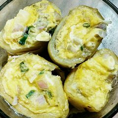 A picture of Egg stuffed potatoes.