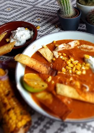 A picture of Tortilla Soup with Chipotle Chilli, Tomato & Avocado.