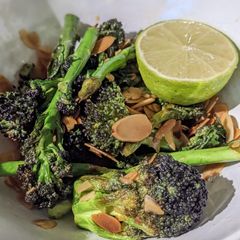 A picture of Stir-fry purple sprouting broccoli with toasted almonds and lime.