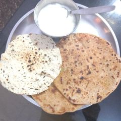 A picture of Cabbage paratha with curd.