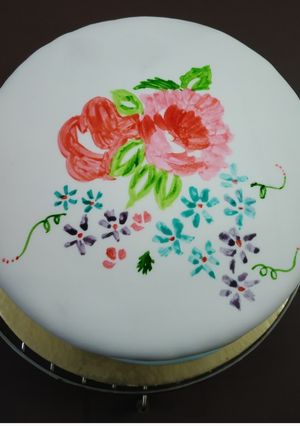 A picture of Eggless chocolate cake with white fondant.