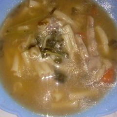 A picture of Brown beans soup with chicken feet.