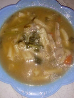 A picture of Brown beans soup with chicken feet.