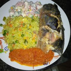 A picture of Fried rice stew, garden salad, frying cat fish.