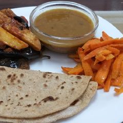 Brinjal n Potatoes with daal n roti n carrots# Indian dish conte A picture of Brinjal n Potatoes with daal n roti n carrots# Indian dish conte.
