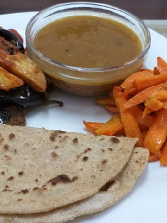 A picture of Brinjal n Potatoes with daal n roti n carrots# Indian dish conte.