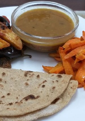 A picture of Brinjal n Potatoes with daal n roti n carrots# Indian dish conte.